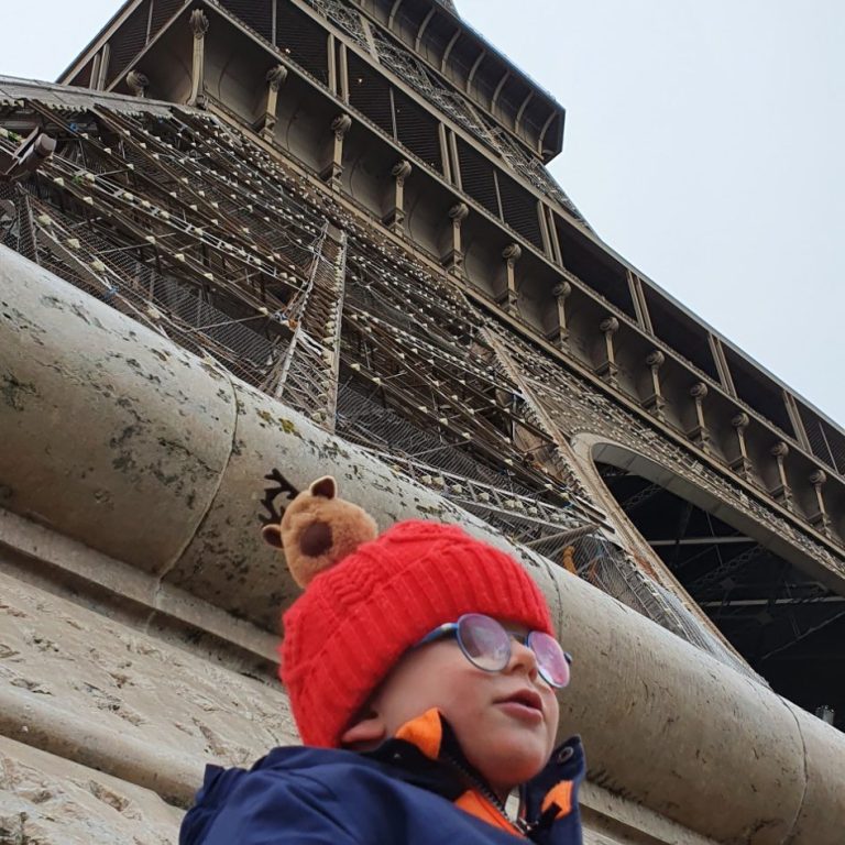 picture bottom up of the Eiffel Tower with my happy son